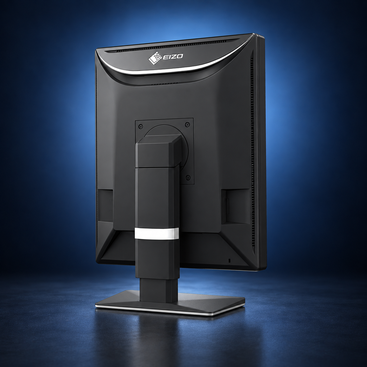 EIZO RadiForce RX570 monitor, angled rear view showing the housing, stand, and base on a dark blue studio background.